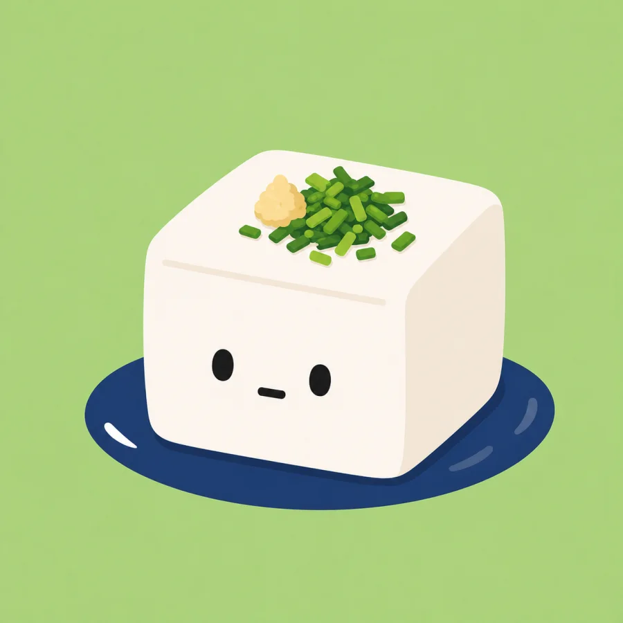 A cute tofu character on a navy plate with nira and ginger.