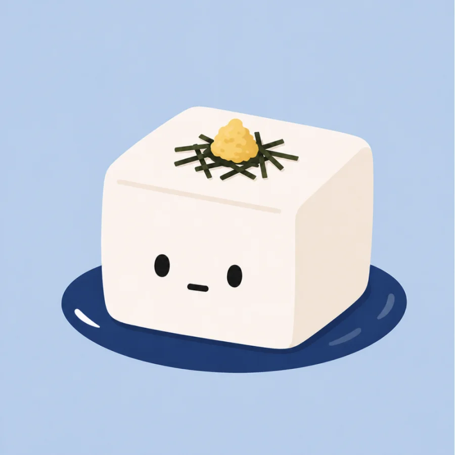 A cute tofu character on a navy plate with kaiware sprouts and sesame.